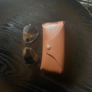 Silver aviator RayBans with dark drey lenses